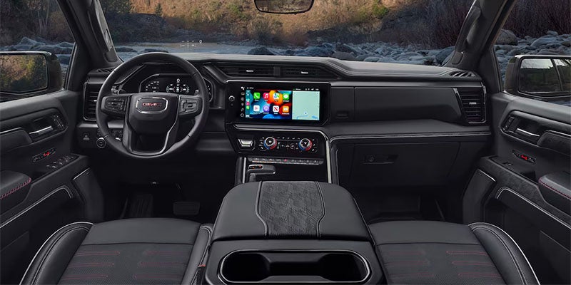 GMC Sierra 1500 dashboard showing touch screen, steering wheel, center console and front seats
